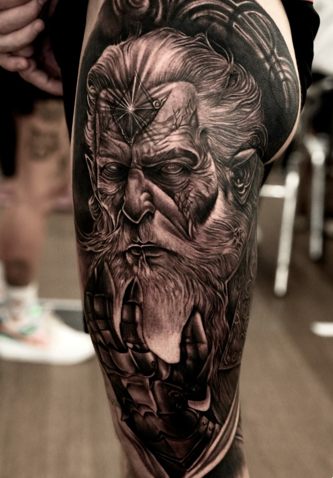 Black and gray realism tattoo of a mythical warrior face in high detail
